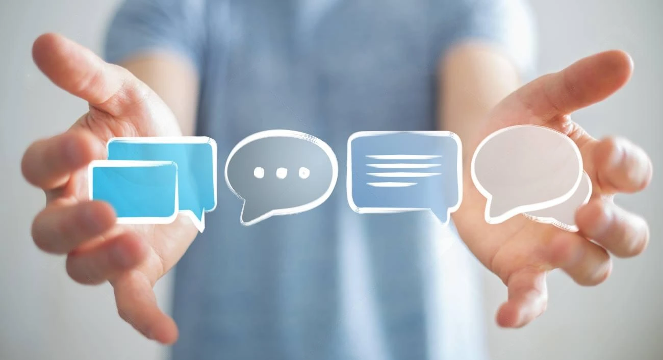 A person extends their hands forward with digital chat and speech bubble icons floating between them, illustrating the concept of a caption generator in action.