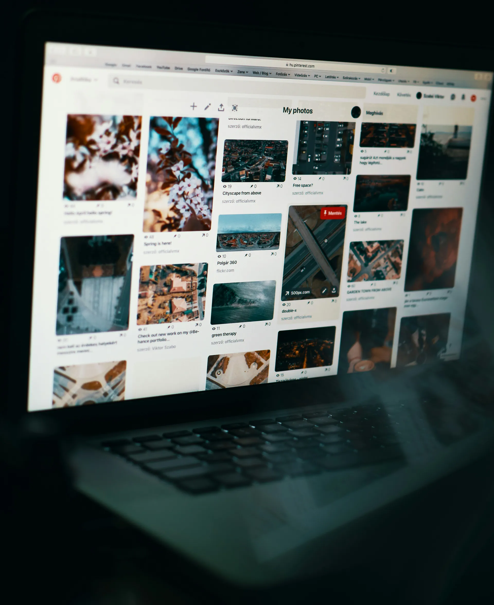 A laptop screen displays a Pinterest page showing a collection of photo pins under the "My photos" board.